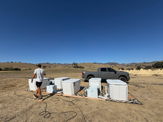 Five white Valley Cold Plunges Freeze XL tubs with chillers set up for a three-day outdoor event near Hollister, California